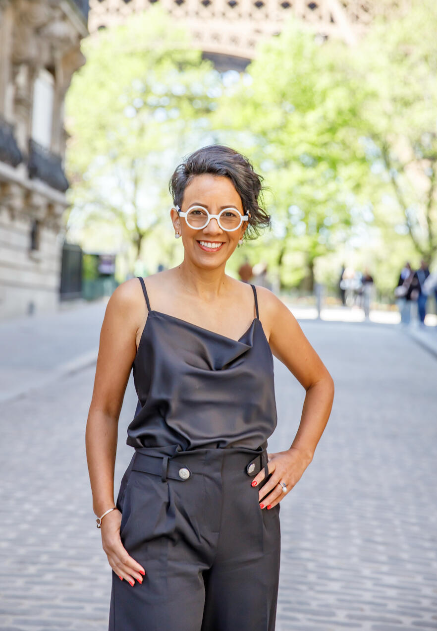 Hoozie Chapman in Paris, standing in the street in front of the Eiffel Tower.